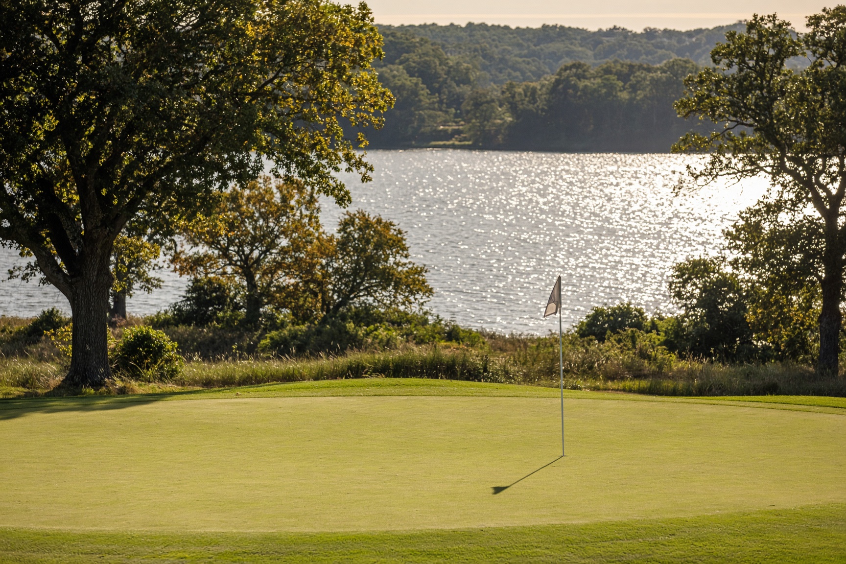 A green with the lake behind the flag